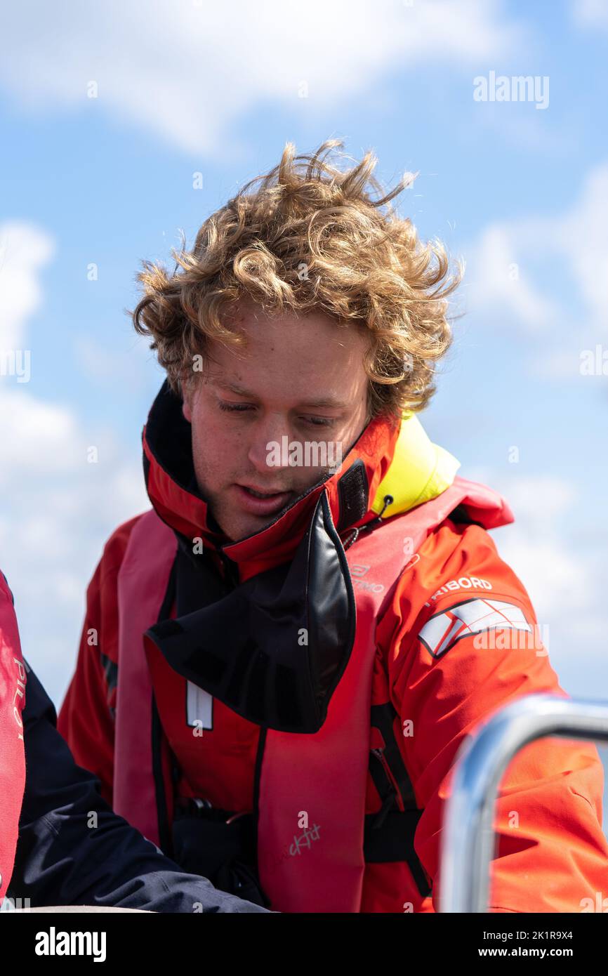 A vertical shot of a young sailer looking on the boat Stock Photo