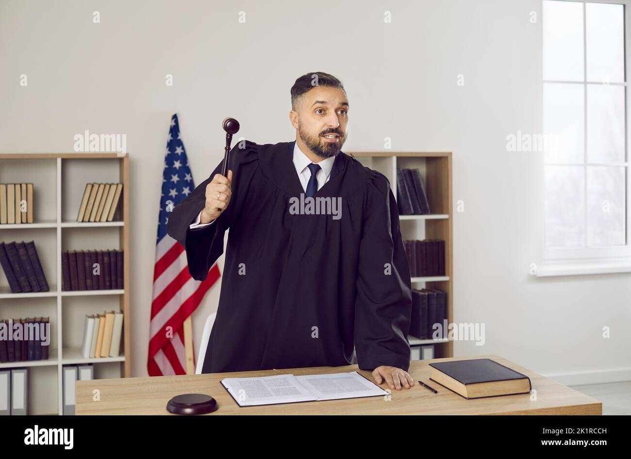 Male attorney make verdict hit gavel in court Stock Photo