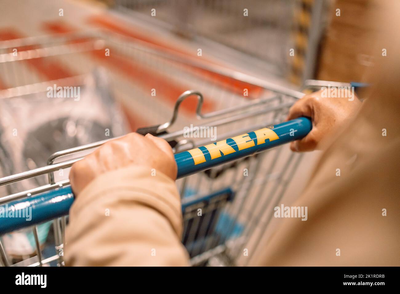 Krakow, Poland - April 26, 2022: Customer with trolley in IKEA shop in Poland. IKEA is a multinational group of Swedish companies that designs and Stock Photo