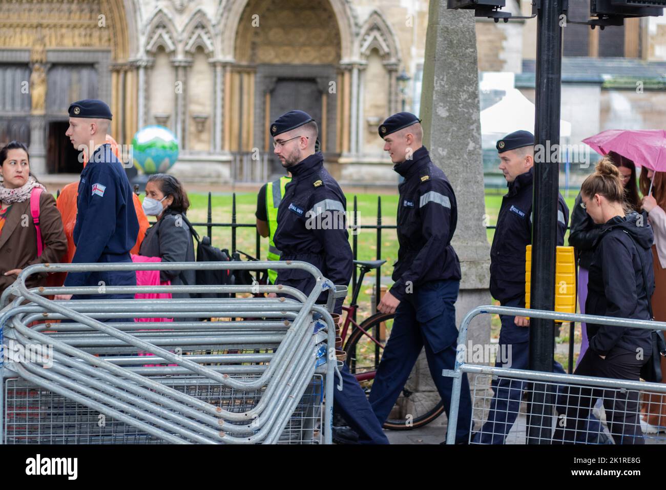 The police officers walking with the crowd of civilians during Queen Elizabeth's funeral preparations Stock Photo
