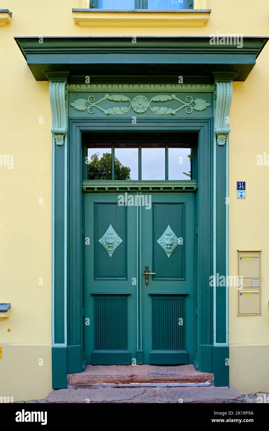 Richly decorated front door with knockers, listed house of Bliedenstrasse no. 34 from the Classicist period, historic Old Town of Wismar, Germany. Stock Photo