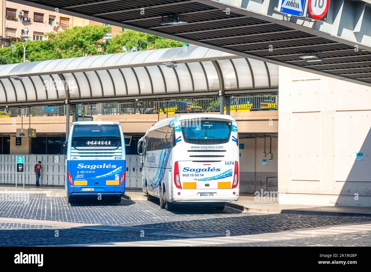 Barcelona Nord Bus Station. Two stationary buses in the platform of the transportation building. They have a sign reading 'Sagales.' Stock Photo