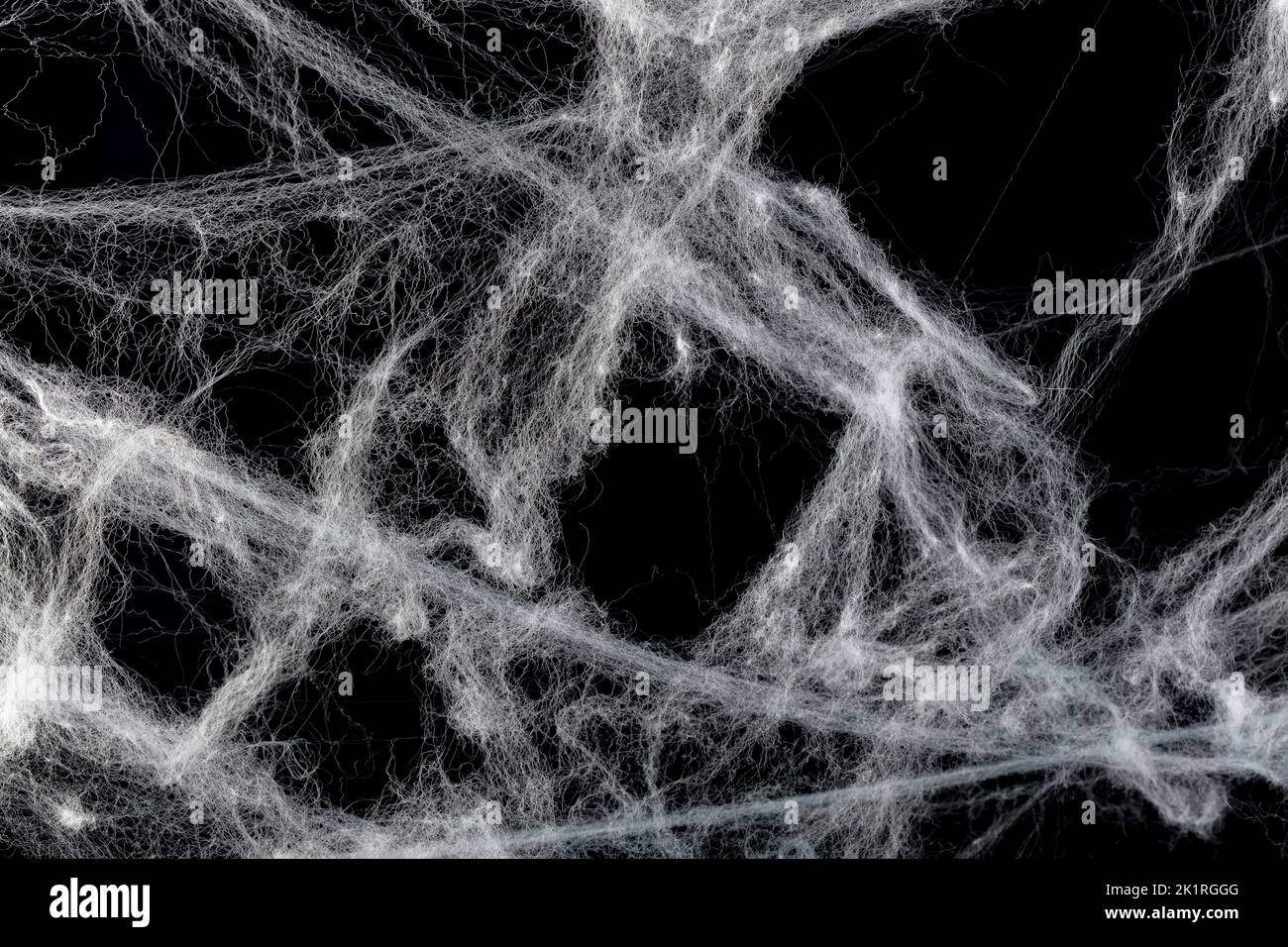 Cobweb or spider's web against a black background, to be used as overlay for Halloween designs Stock Photo