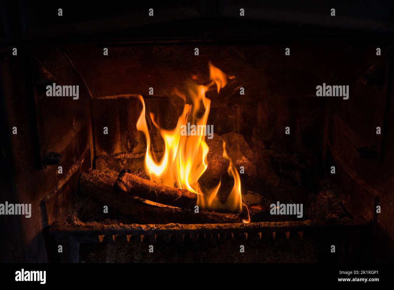 Closeup of fire burning in an old fireplace, can be used to composite in an existing image with unused fireplace Stock Photo