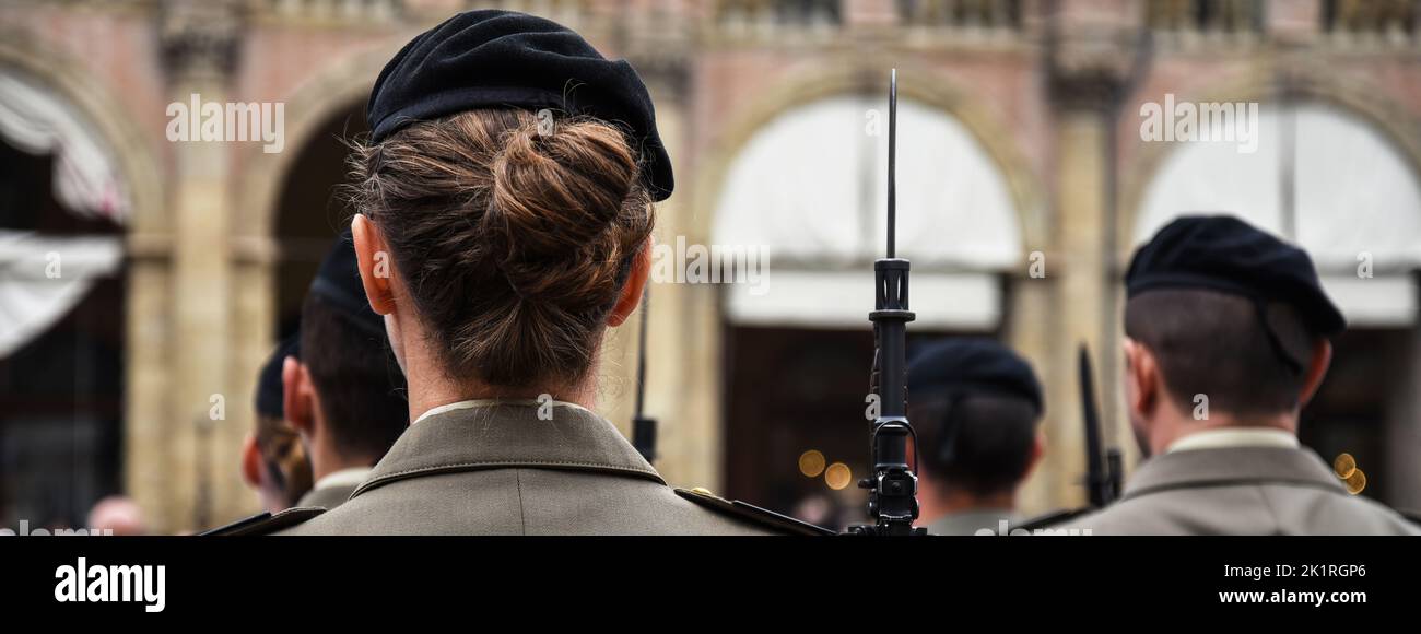 Horizontal banner or header with uniformed women standing during the military ceremony in Bologna, Italy. In the foreground, a woman seen from behind Stock Photo