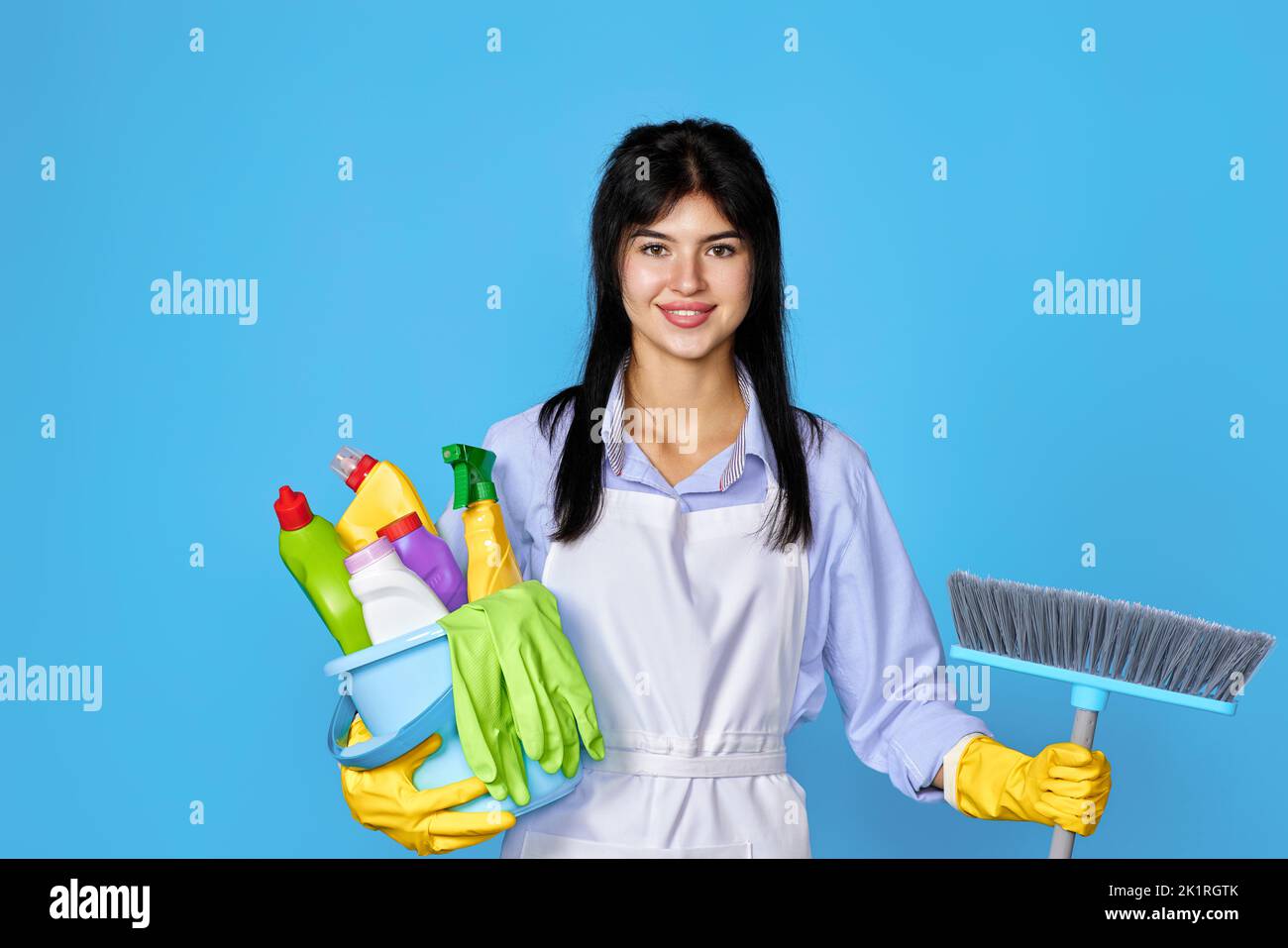 woman in gloves holding bucket of detergents and broom Stock Photo - Alamy