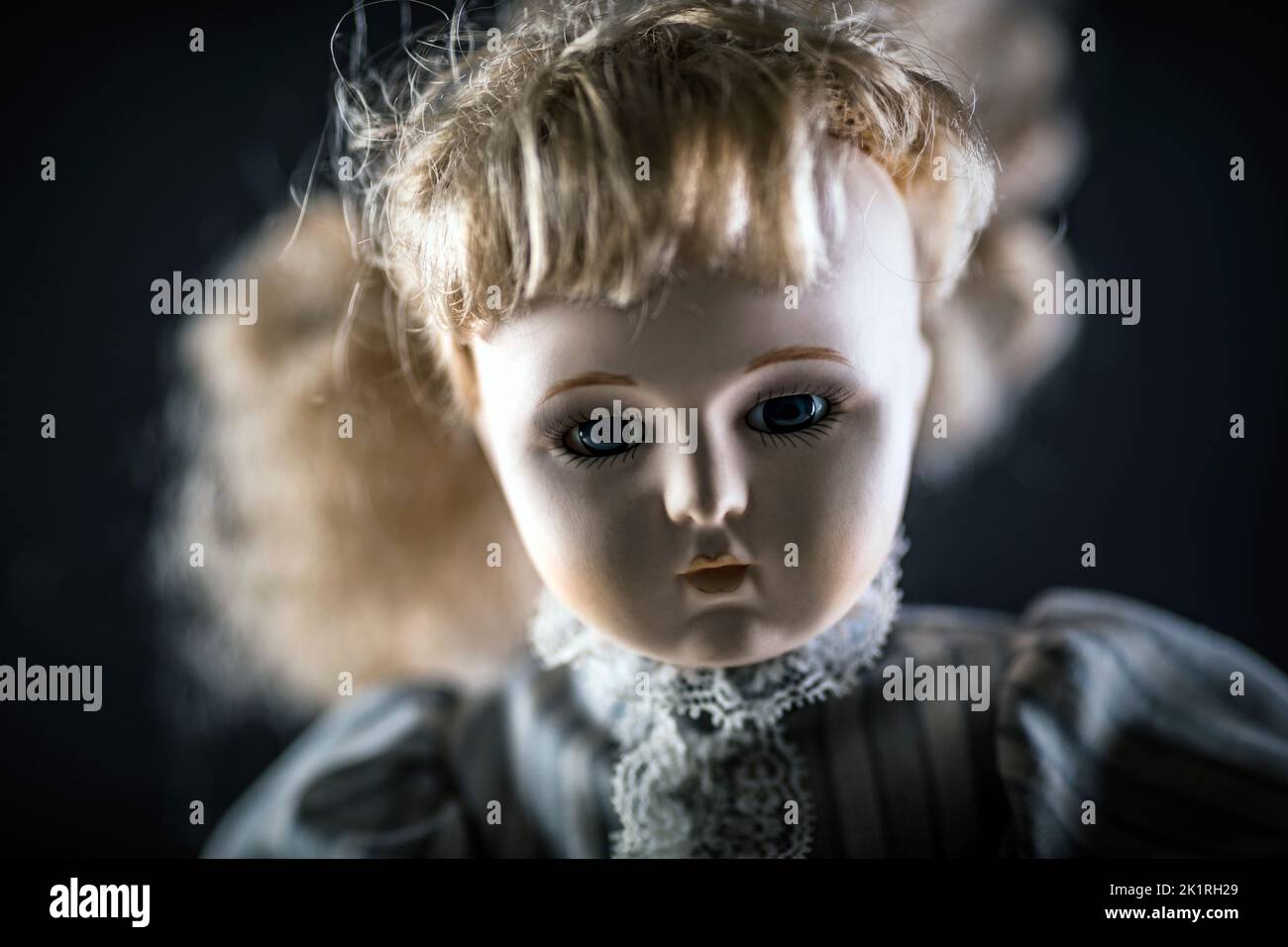 Vintage doll face on dark background Stock Photo
