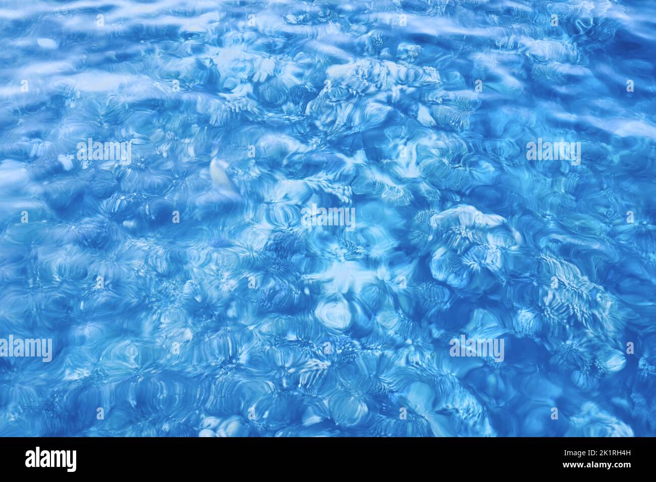 Motion blurred picture of shallow sea water, abstract nature blue background. Stock Photo