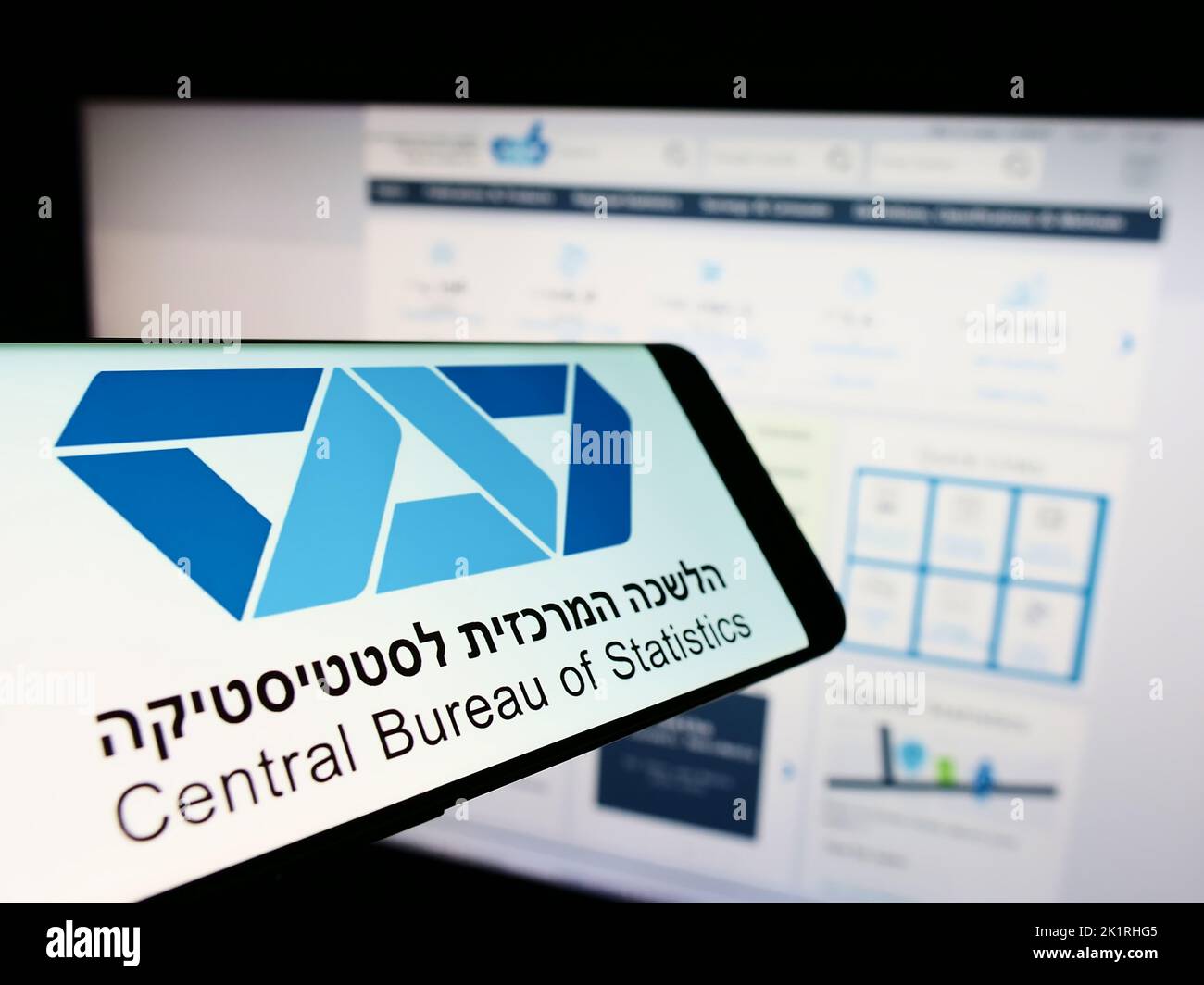 Smartphone with logo of Israel Central Bureau of Statistics (CBS) on screen in front of website. Focus on center-right of phone display. Stock Photo