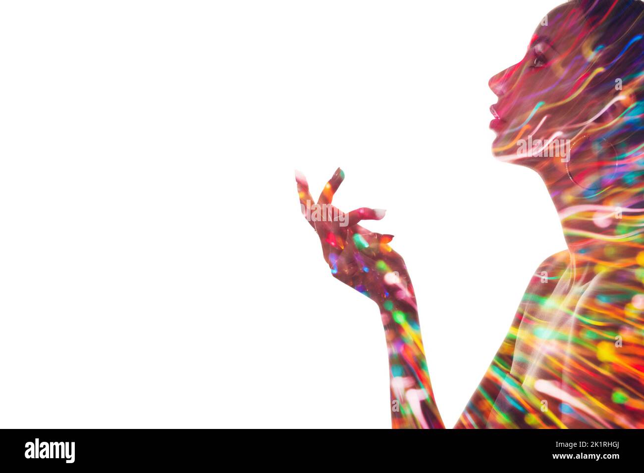 Double exposure silhouette. Fashion beauty. Makeup art. Blur colorful neon light splash in profile portrait of woman presenting invisible product with Stock Photo