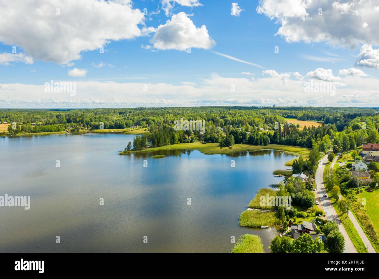 An aerial view of green lake surrounded by growing lush trees Stock ...