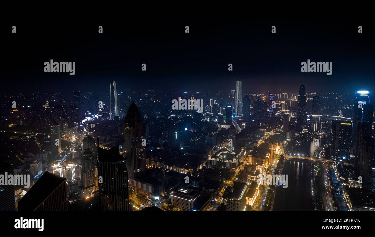 An aerial view of a modern city with bright colorful lights on ...