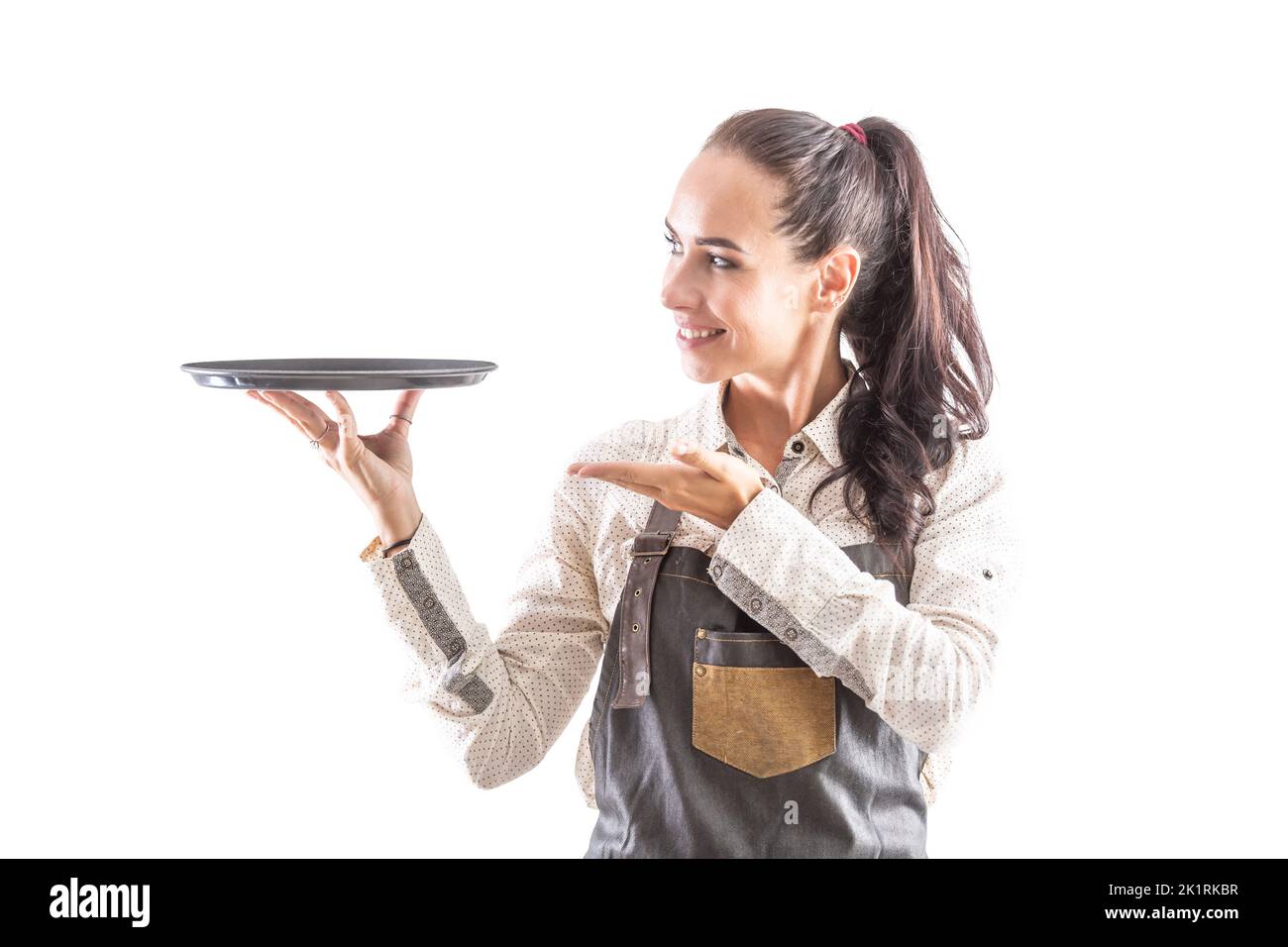 Waitress in apron holding empty tray on isolated white background. Stock Photo