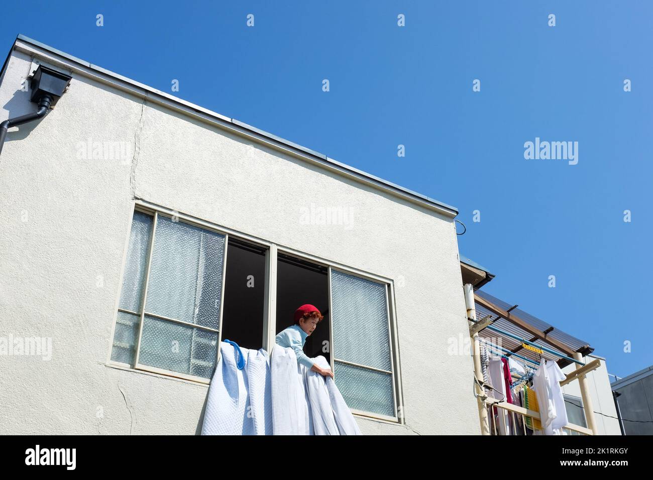 Woman hanging out of window hi-res stock photography and images - Alamy