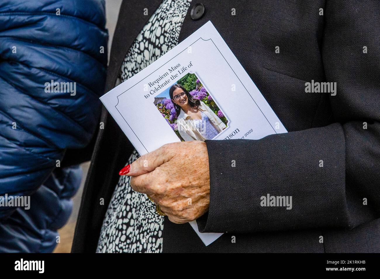 A mourner carries the order of service during the funeral of Hollie Thomson at St Michael's Church, west Belfast. Picture date: Tuesday September 20, 2022. Stock Photo