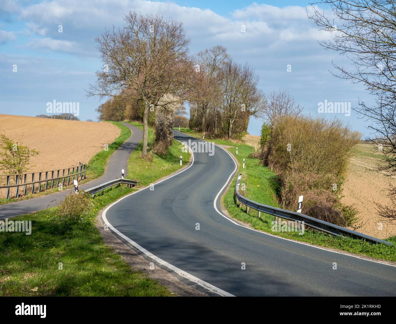 Rural road between town Schleswig and the baltic sea, spring, Germany Stock Photo