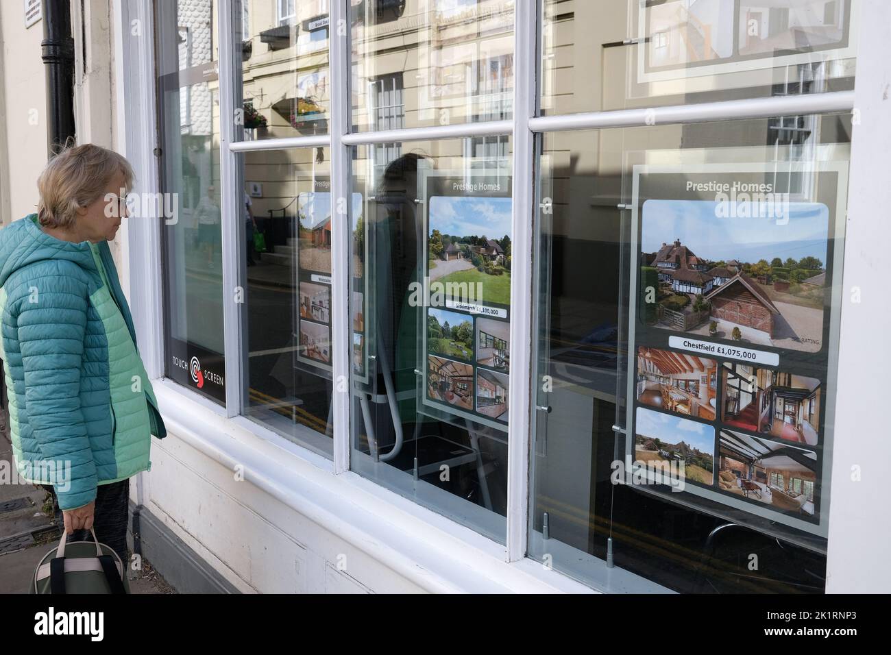 lady looking at the window display in the estate agents shop in castle