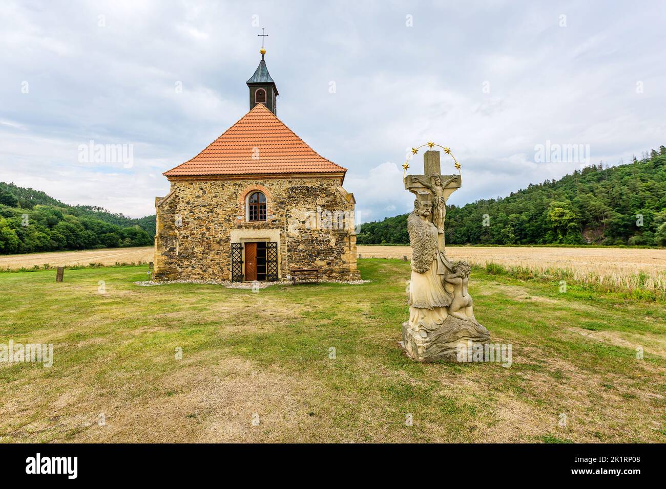 Dolany, Czech Republic - July 30 2022: View of gothic church from 13th century made of stone dedicated to Saint Peter and Paul. The statue of John of Stock Photo