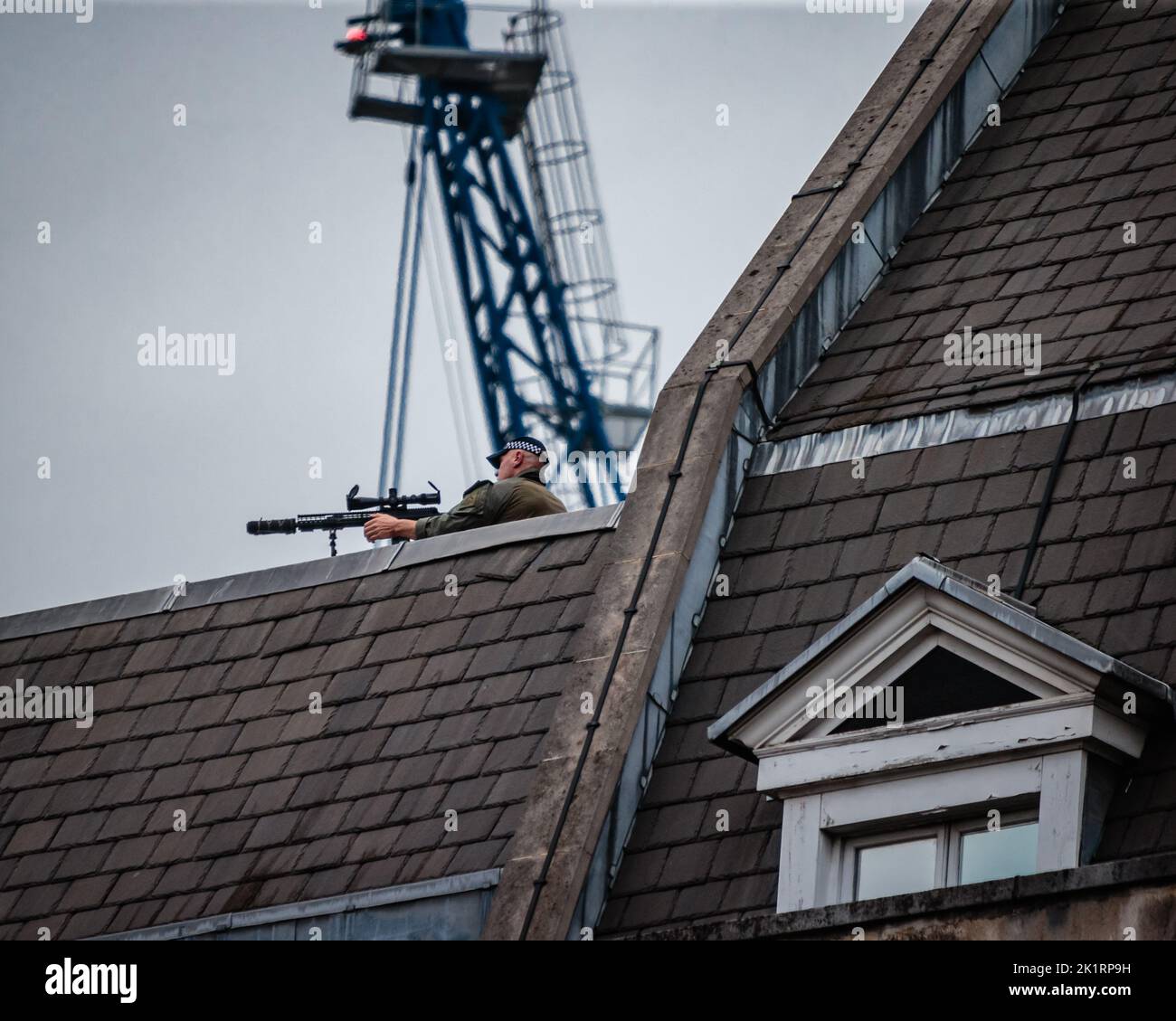 A sniper takes aim atop a building in Whitehall, London during the Queen's funeral. Stock Photo