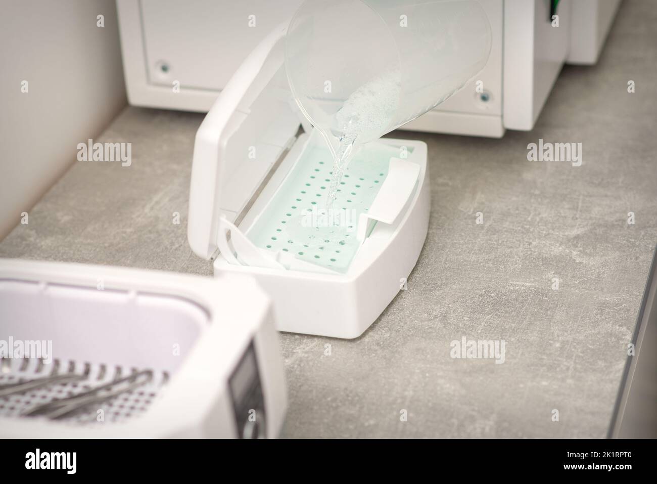 Adding liquid for disinfection of instruments to the machine for ...