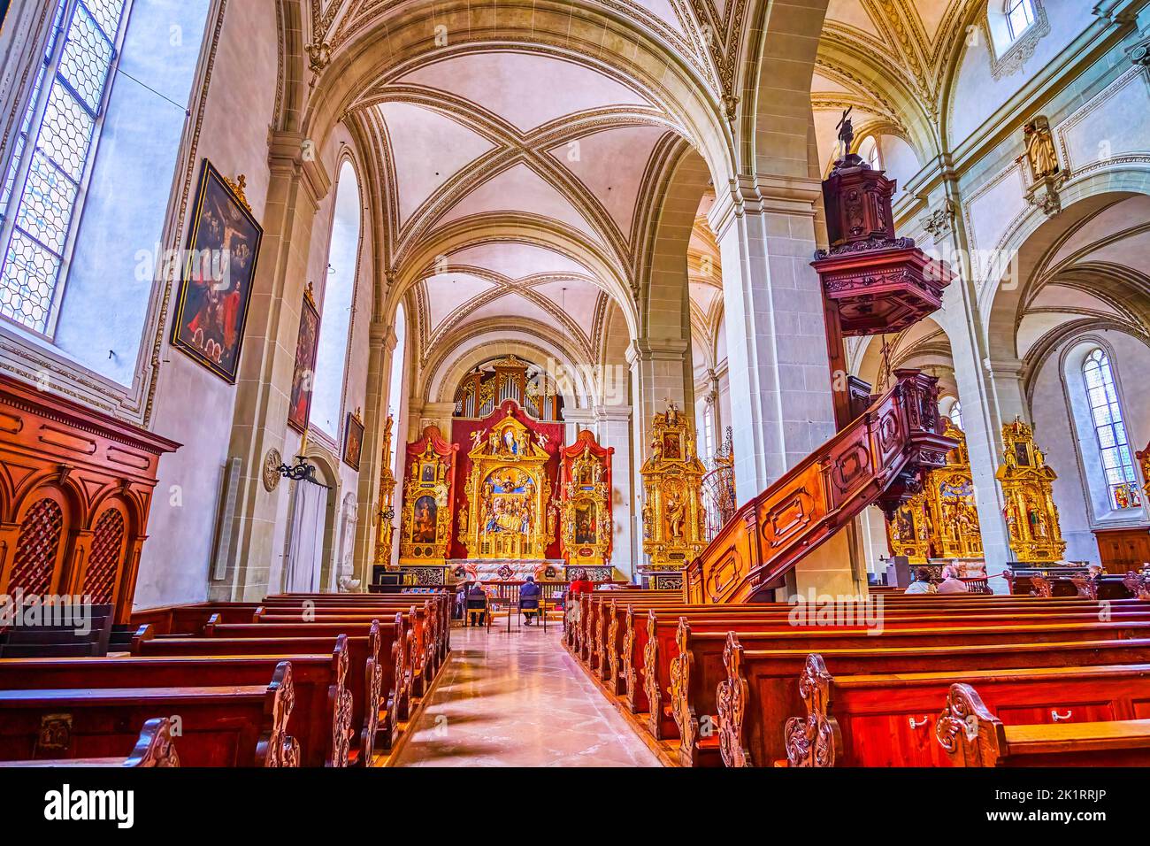 LUCERNE, SWITZERLAND - MARCH 30, 2022: St The side Altarpiece of St. Leodegar Church decorated with carved golden finish, on March 30 in Lucerne, Swit Stock Photo