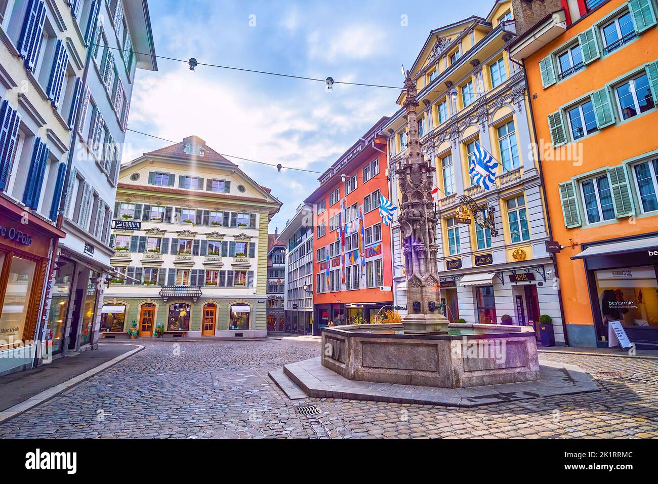 LUCERNE, SWITZERLAND - MARCH 30, 2022: Neat medieval Weinmarkt square in the heart of Altstadt with historical fountain on March 30 in Lucerne, Switze Stock Photo