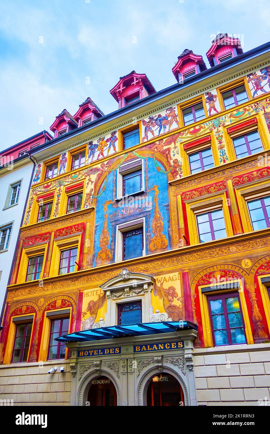 LUCERNE, SWITZERLAND - MARCH 30, 2022: Scenic facade with historic wall frescoes of old Hotel de Balances, on March 30 in Lucerne, Switzerland Stock Photo