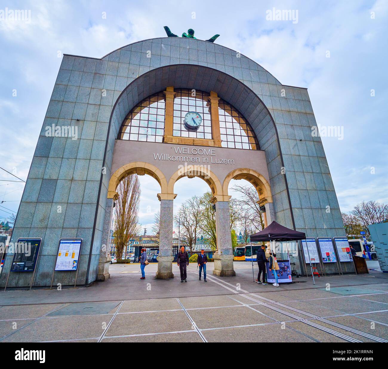 LUCERNE, SWITZERLAND - MARCH 30, 2022: The modern backside of historical arch with welcoming sign in front of Lucerne Railway Station, on March 30 in Stock Photo