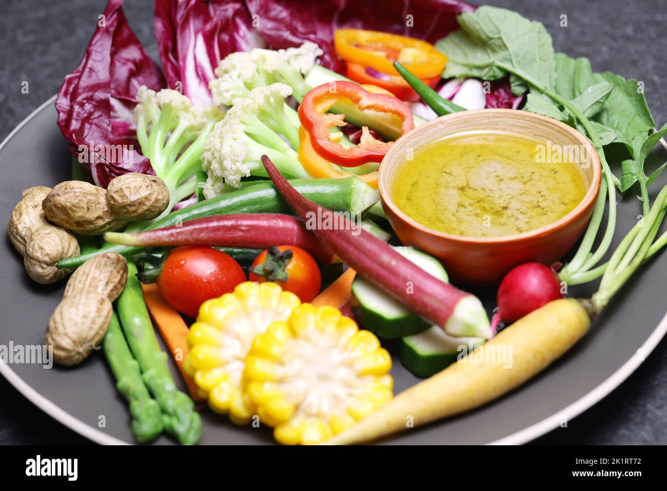 vegetable salad and bagna cauda (a garlic and anchovy sauce for dipping vegetables) Stock Photo