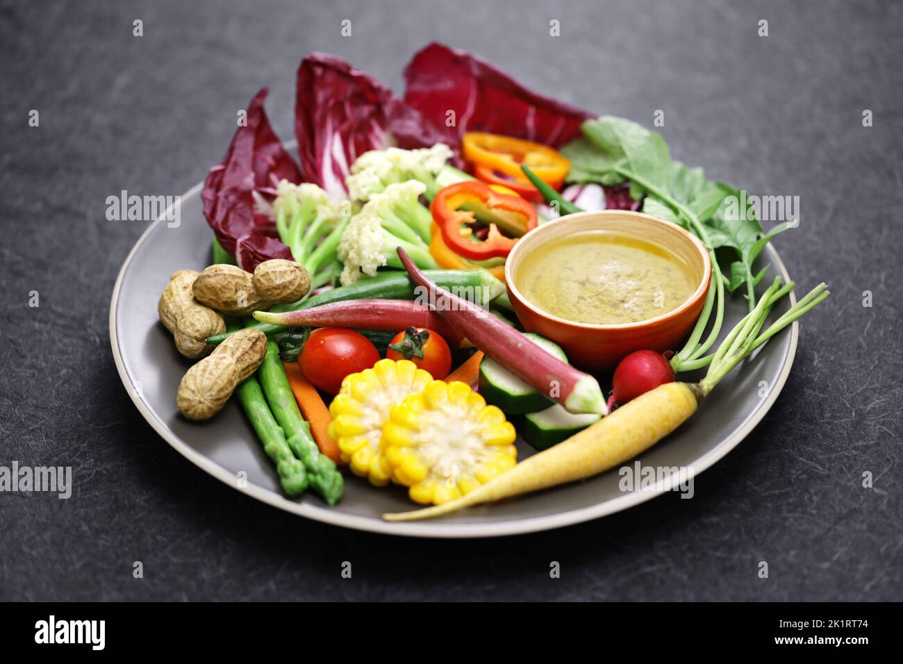 vegetable salad and bagna cauda (a garlic and anchovy sauce for dipping vegetables) Stock Photo