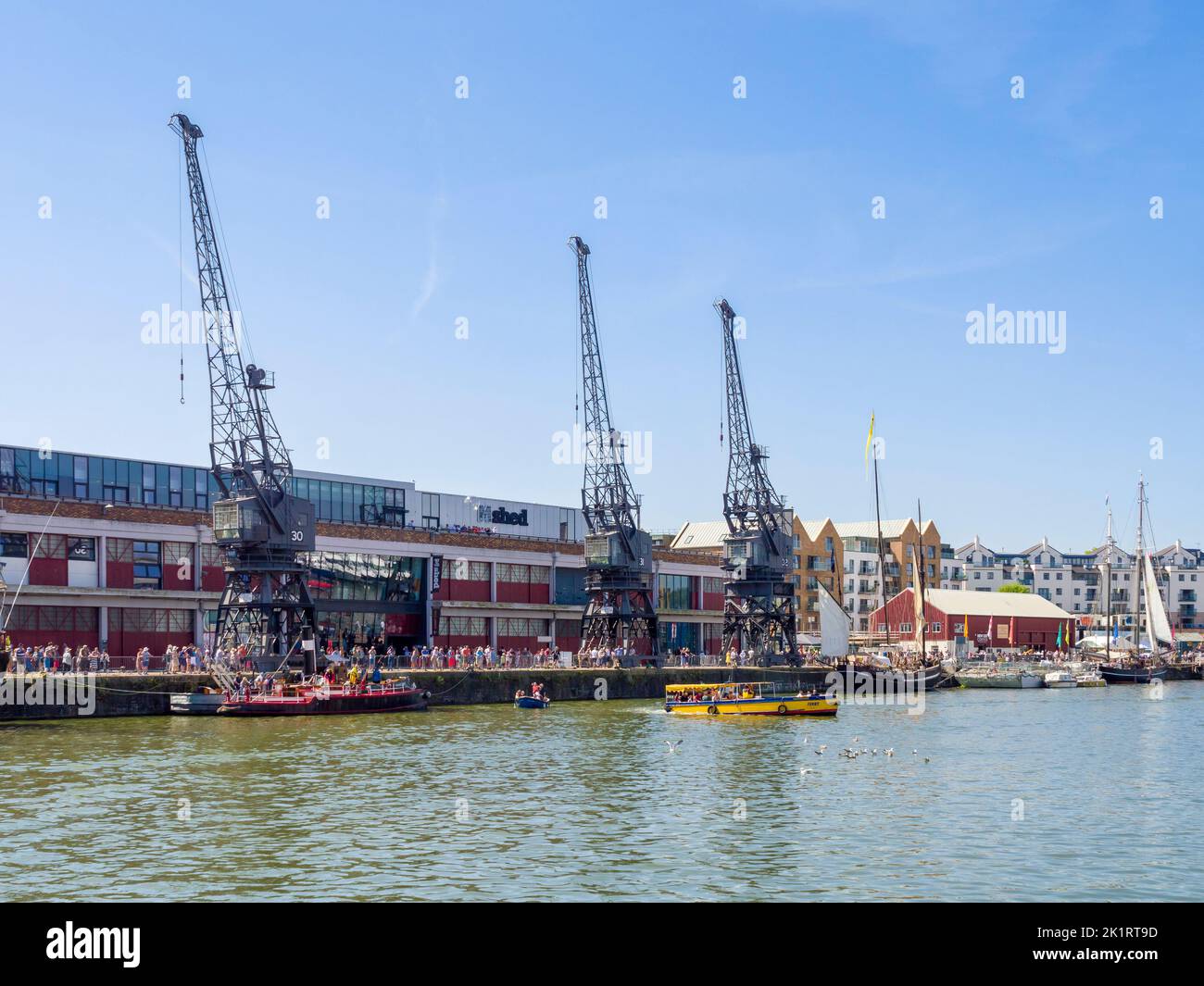The old cranes on the quay side outside the M Shed Museum at the Bristol floating harbour during the Bristol Harbour Festival in 2022, England, UK. Stock Photo