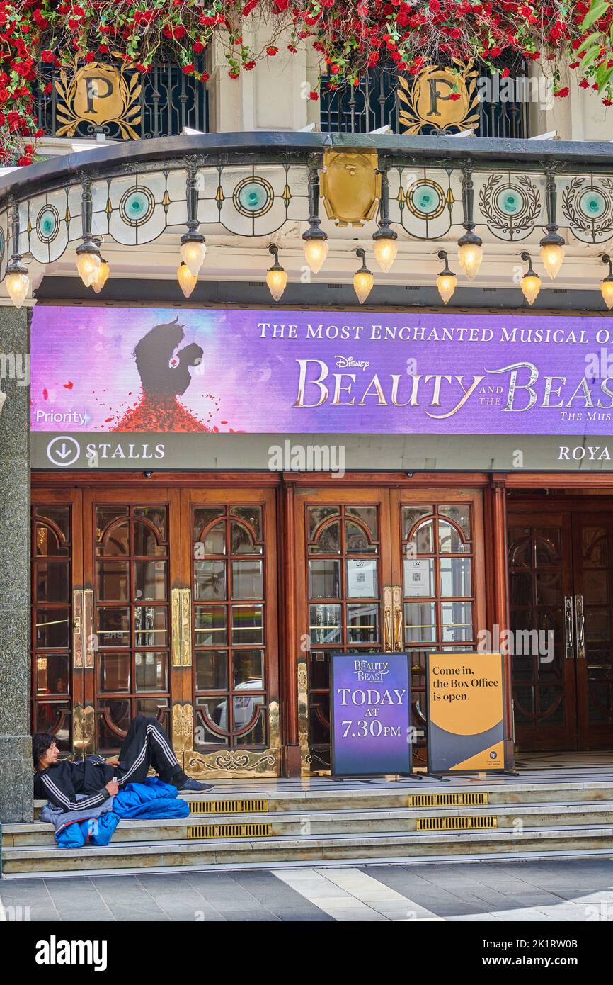 A homeless sleeper outside the Palladium theatre, London, England. currently performing The musical 'Beauty and the Beast'. Stock Photo