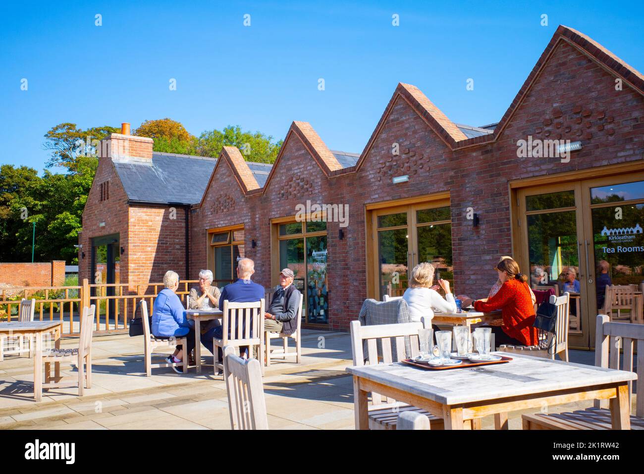 Exterior of the Tea rooms at the Kirkleatham Walled Garden visitor attraction with people at tables outside on a sunny autumn day Stock Photo