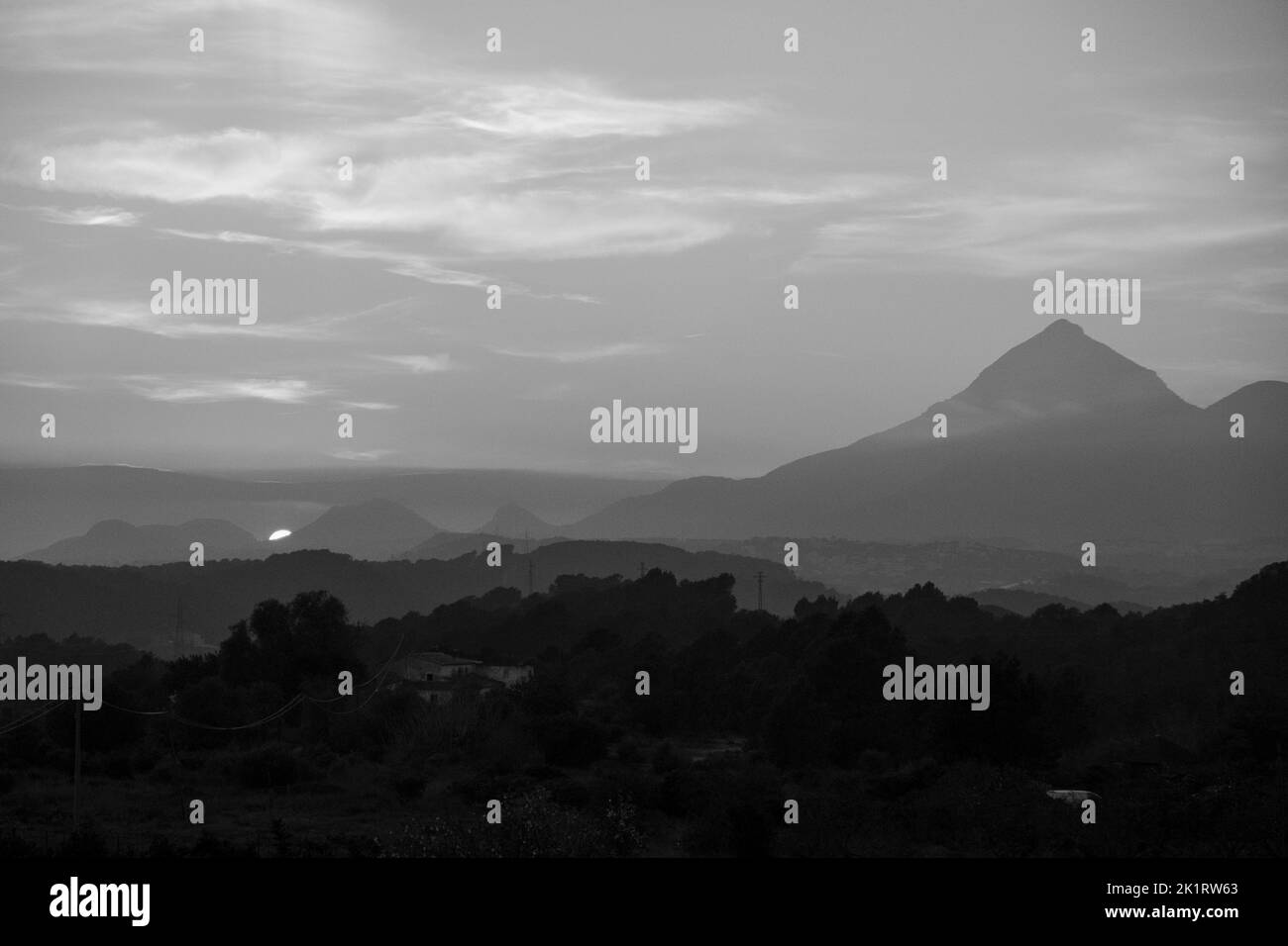 Sunset in black and white behind a mountain range near Altea, Alicante province, Spain, January 2020 Stock Photo