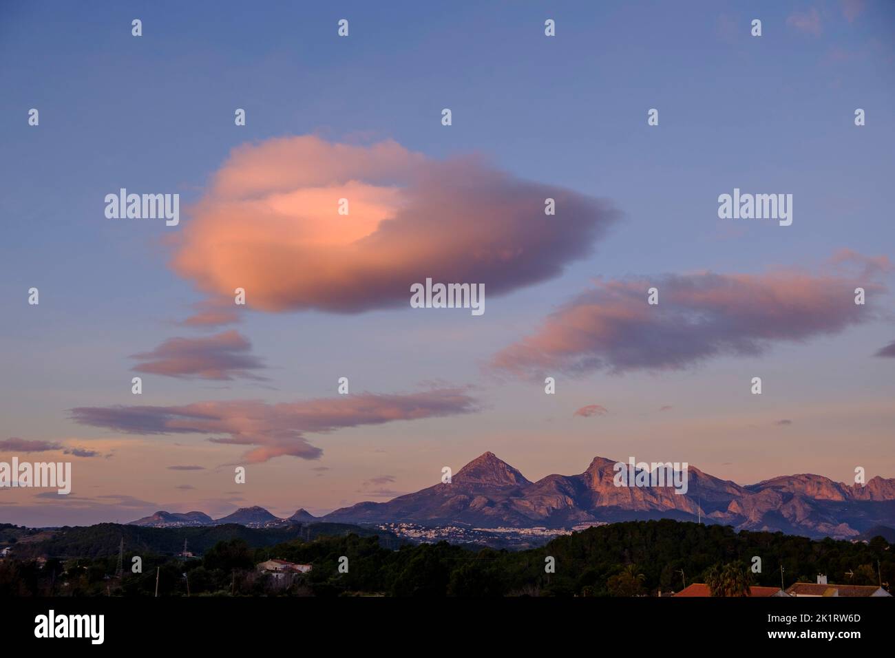 Morning cloud formation over the Puig Campana mountain and the Sierra Aitana mountain range with the villages of La Nucia and Polop near Altea, Alicante province, Spain, in January 2020. Stock Photo