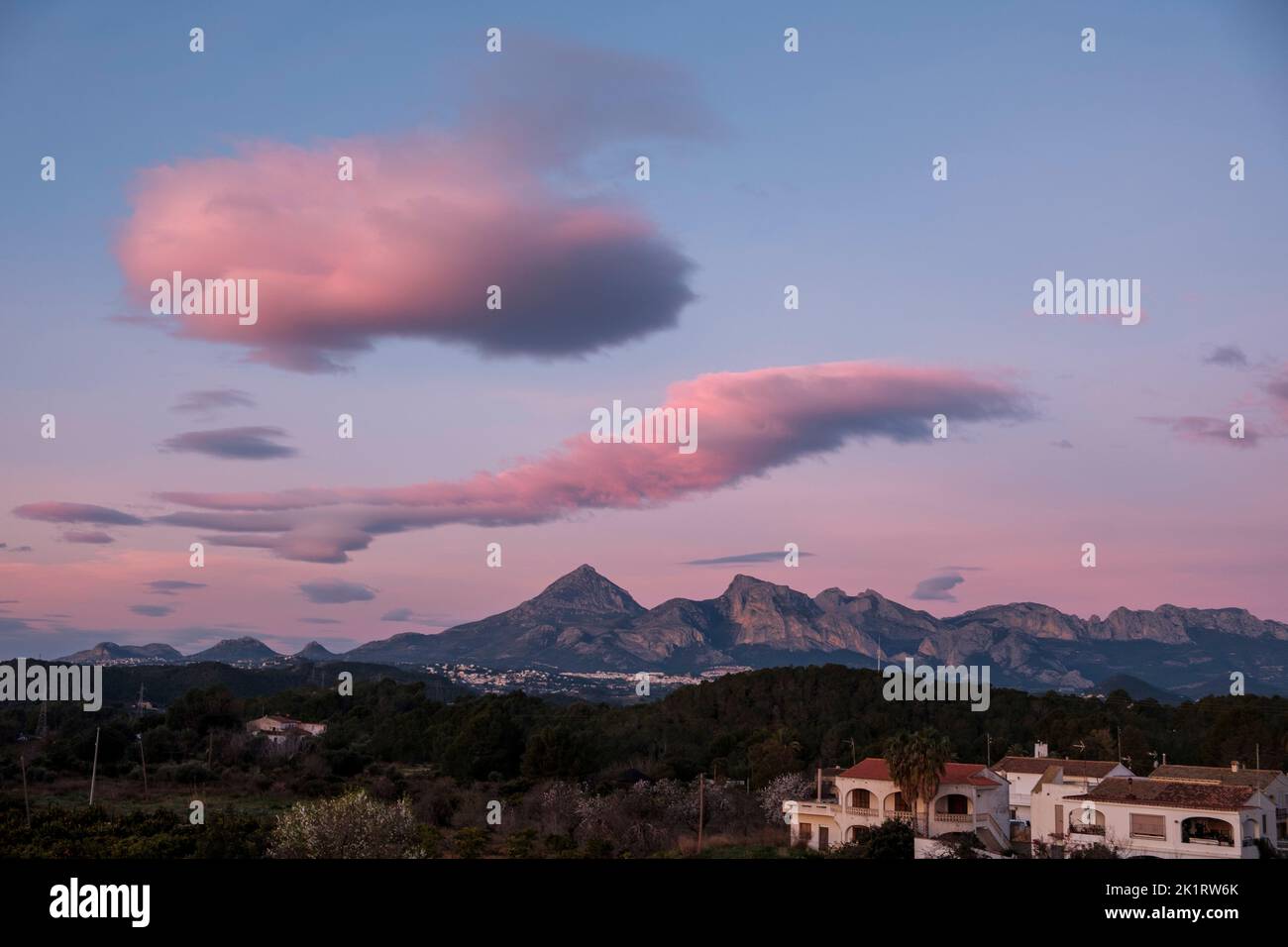 Morning cloud formation over the Puig Campana mountain and the Sierra Aitana mountain range with the villages of La Nucia and Polop near Altea, Alicante province, Spain, in January 2020. Stock Photo