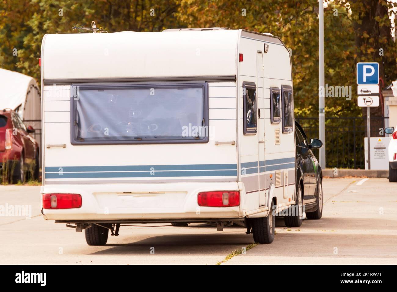 Motor home attached to a car, parking lot Stock Photo