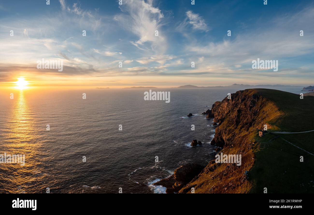 sunset over the Atlantic Ocean and the cliffs of Bray Head on Valentia Island in County Kerry of western Ireland Stock Photo
