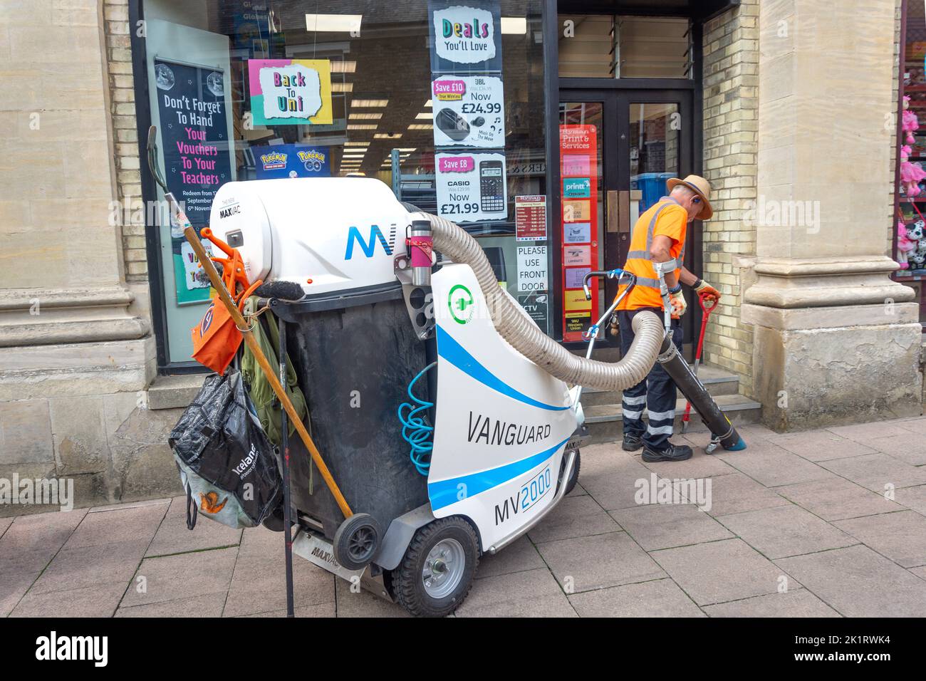 Street cleaner using Vanguard MV2000 urban waste vacuum machine, Cornhill, Bury St Edmunds, Suffolk, England, United Kingdom Stock Photo