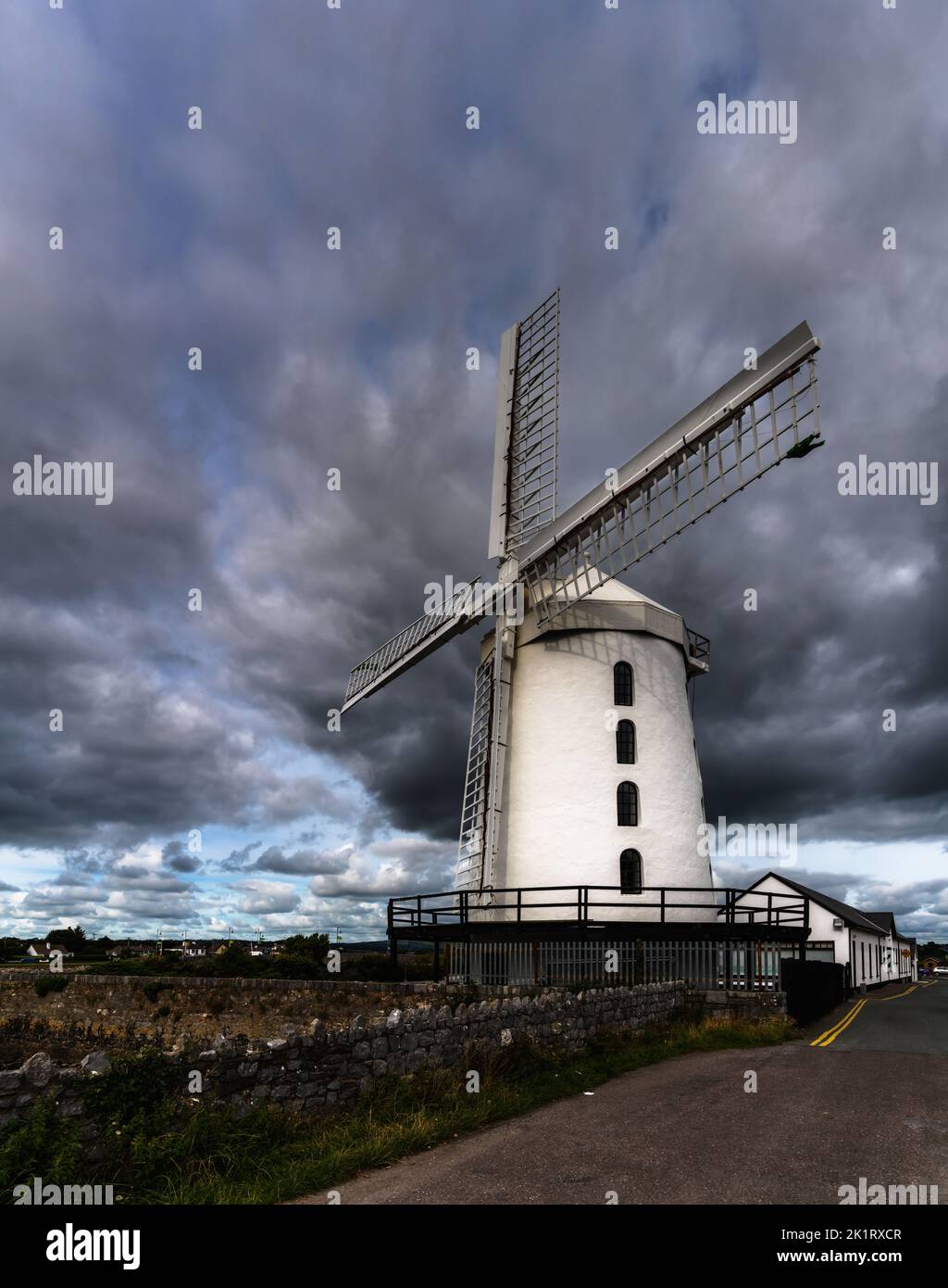 Blennerville, Ireland - 5 August, 2022: view of the historic Blennerville Windmill in Tralee Bay in western Ireland under stormy skies Stock Photo