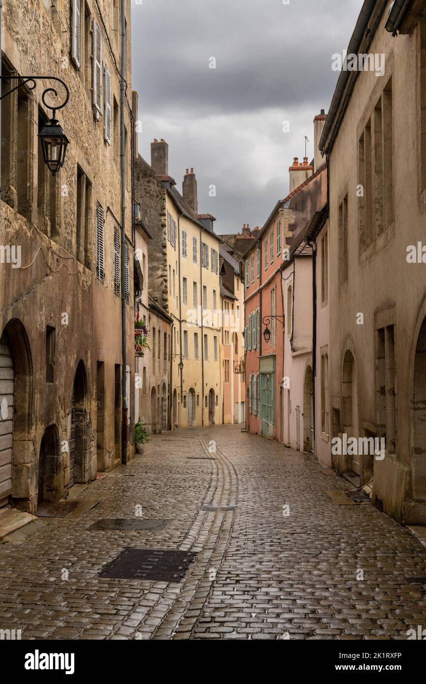 Dole, France - 14 September, 2022: deserted city streets in the center of Dole with historic art nouveau buildings and cobblestone street under an ove Stock Photo