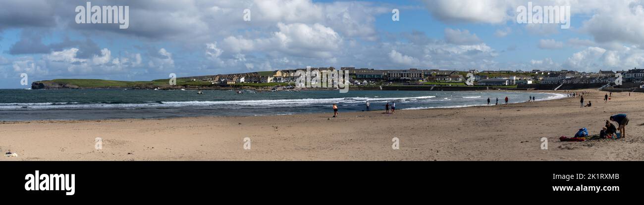 Kilkee, Ireland - 4 August, 2022: people enjoy a warm summer day on the golden sand beach of Kilkee in western Ireland Stock Photo