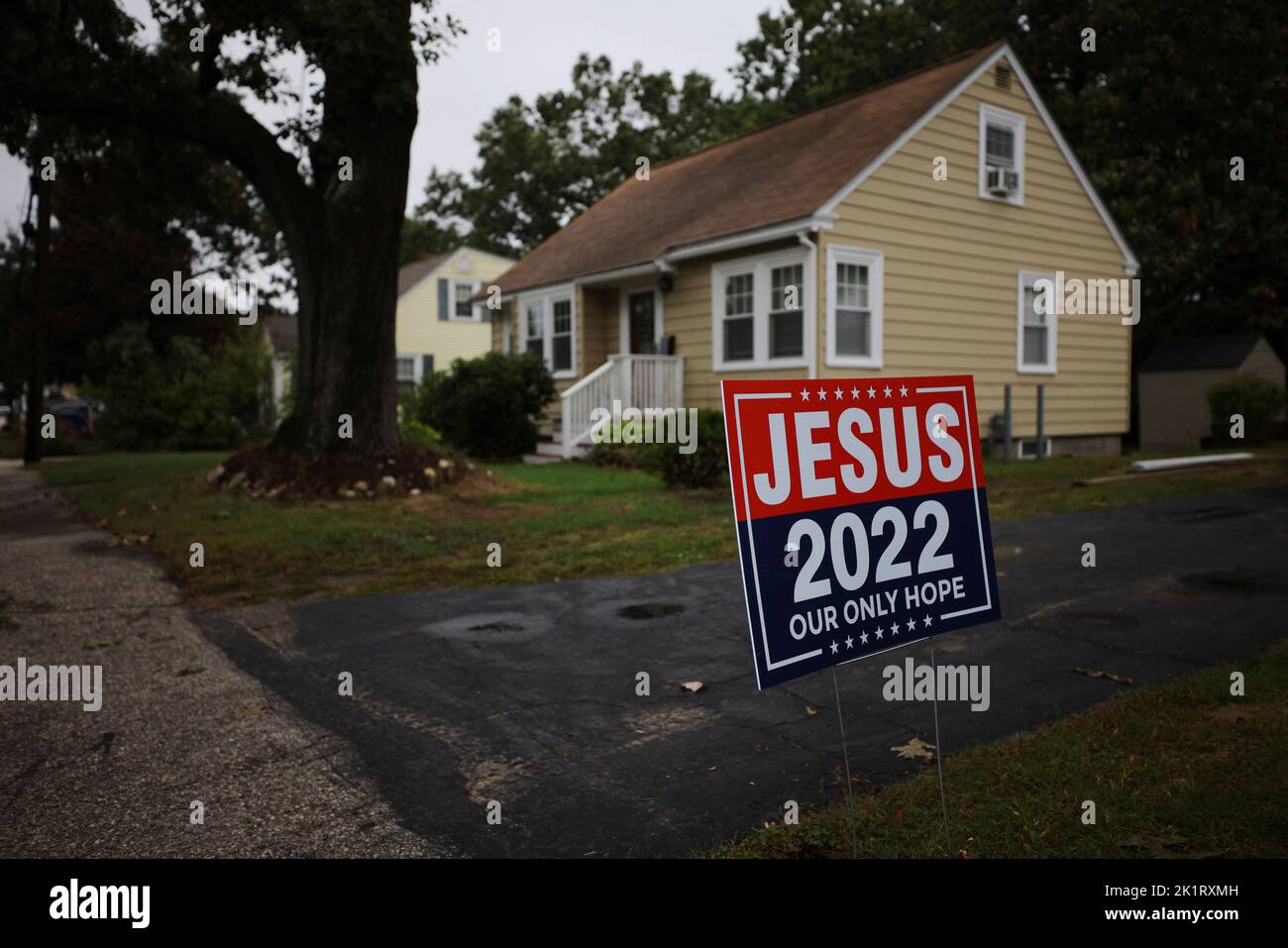 A political campaign style sign reading 'Jesus 2022' stands in a residential neighborhood in Manchester, New Hampshire, U.S., September 20, 2022.     REUTERS/Brian Snyder Stock Photo