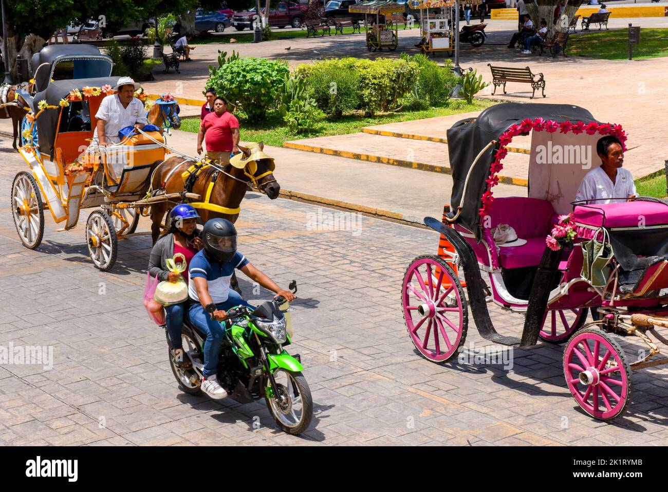 Daily life, Motorbikes and horses carriages in the town of Izamal , Yucatan, Mexico Stock Photo