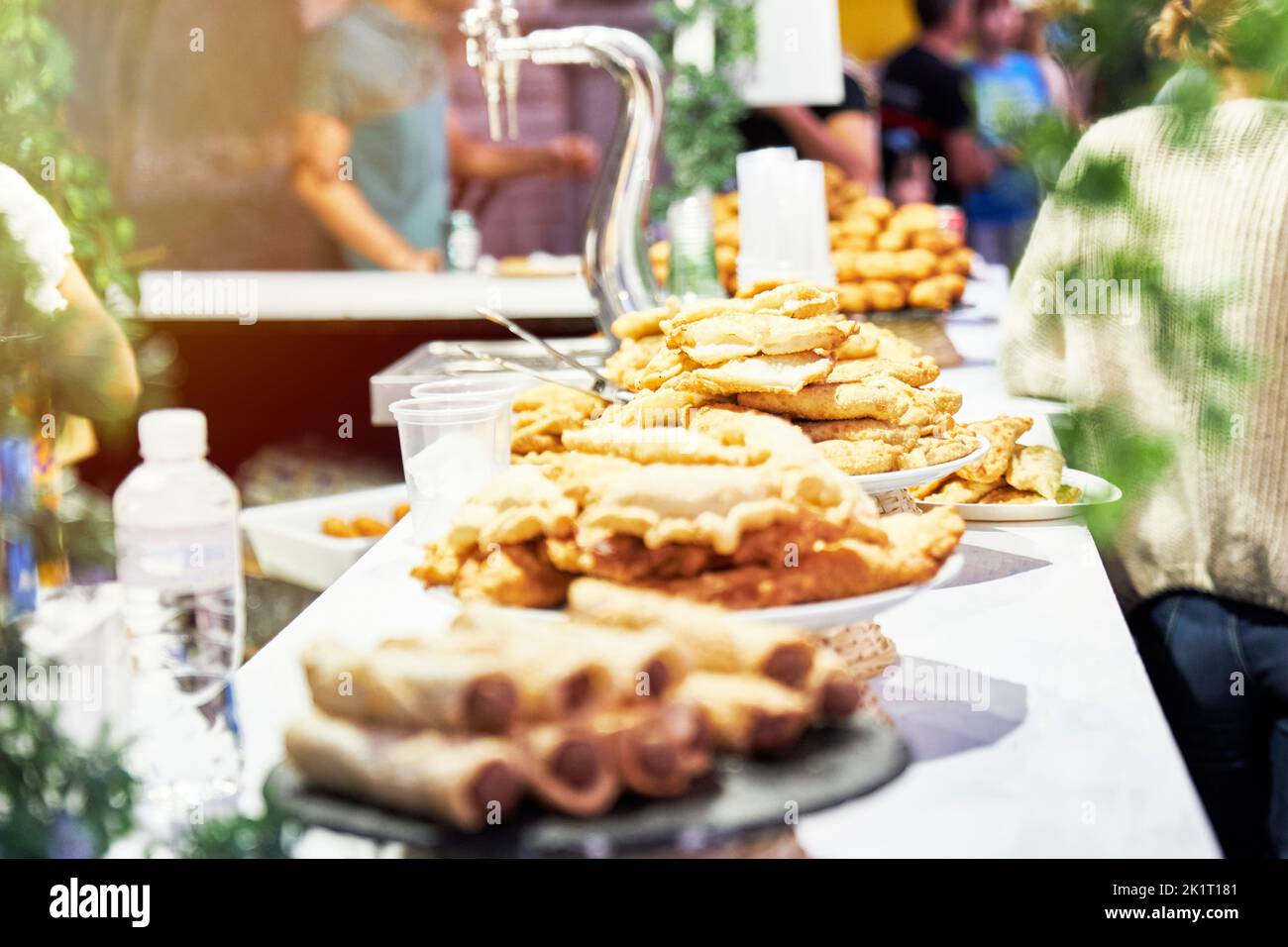 Bar counter with plates of sausages, croquettes and pasties and blur effect. Lifestyle and fun Stock Photo