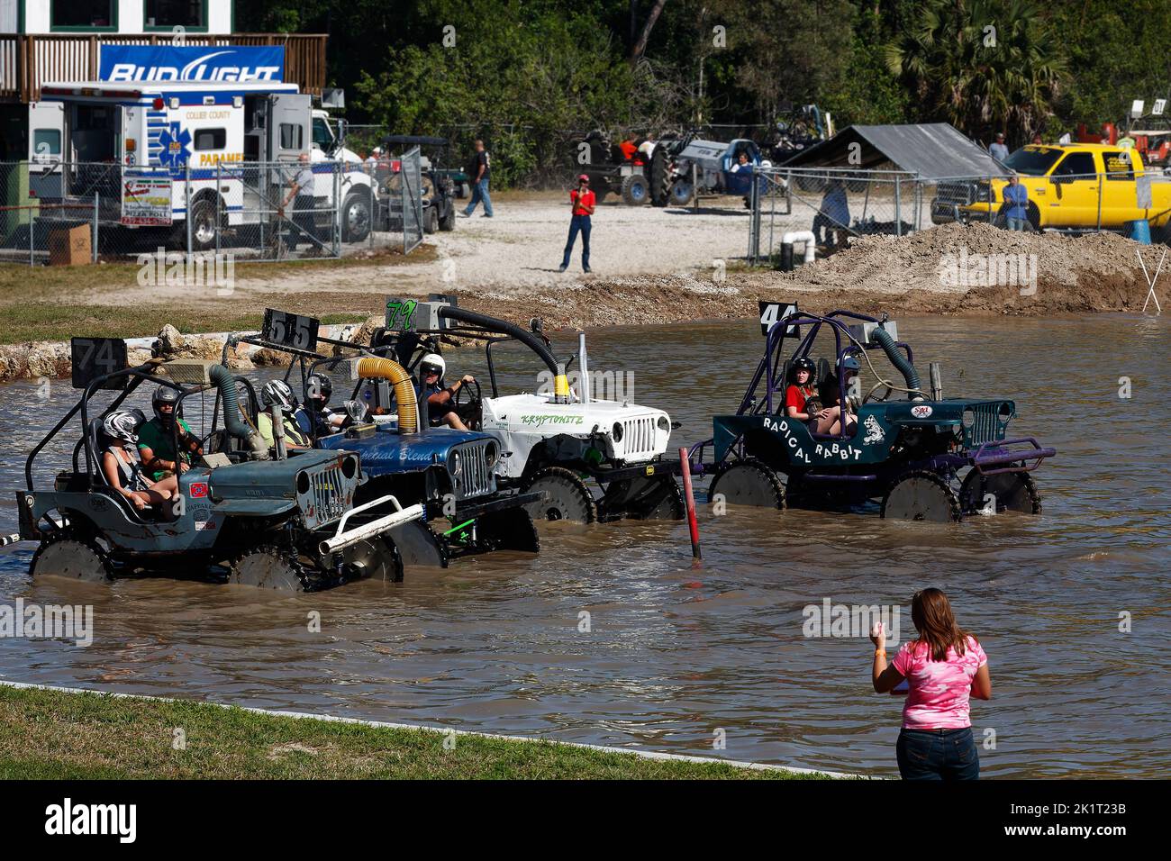 swamp buggies lined up, in water, starting race, vehicle sport, fast, contestants wear helmets, jeeps, spectators, Florida Sports Park, Naples, FL Stock Photo