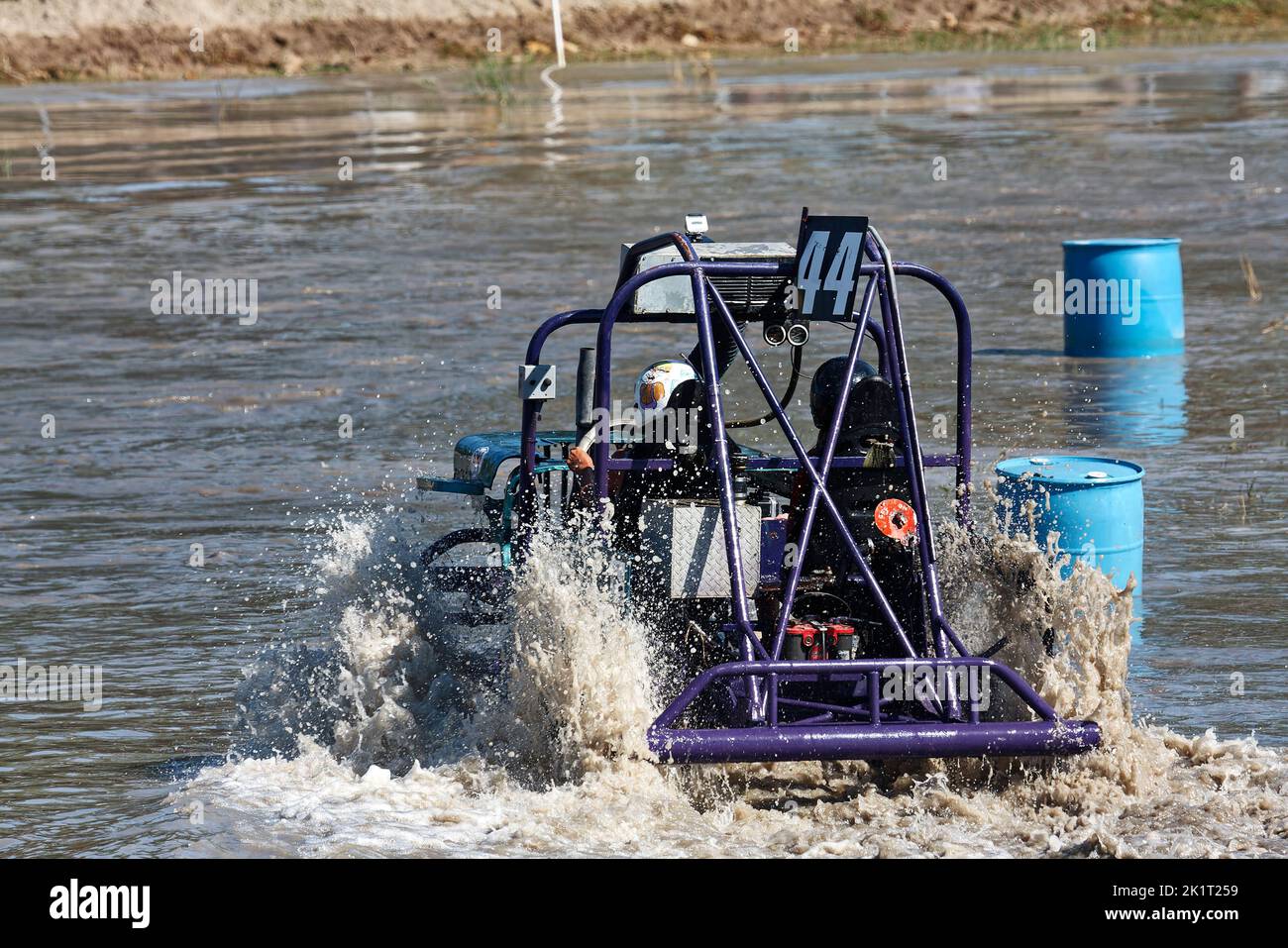 swamp buggy moving through water; action; water splashing; jeep style; vehicle sport; close-up; rear view; going around barrels; Florida Sports Park; Stock Photo