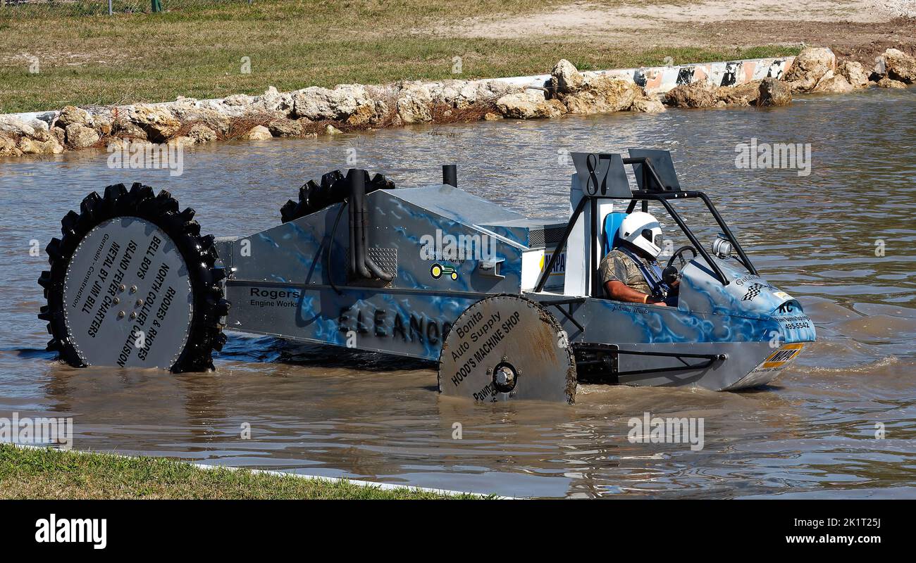 swamp buggy sitting in water, ready to race, close-up, jeep style, large wheels, man, helmet, vehicle sport, Florida Sports Park, Naples, FL Stock Photo