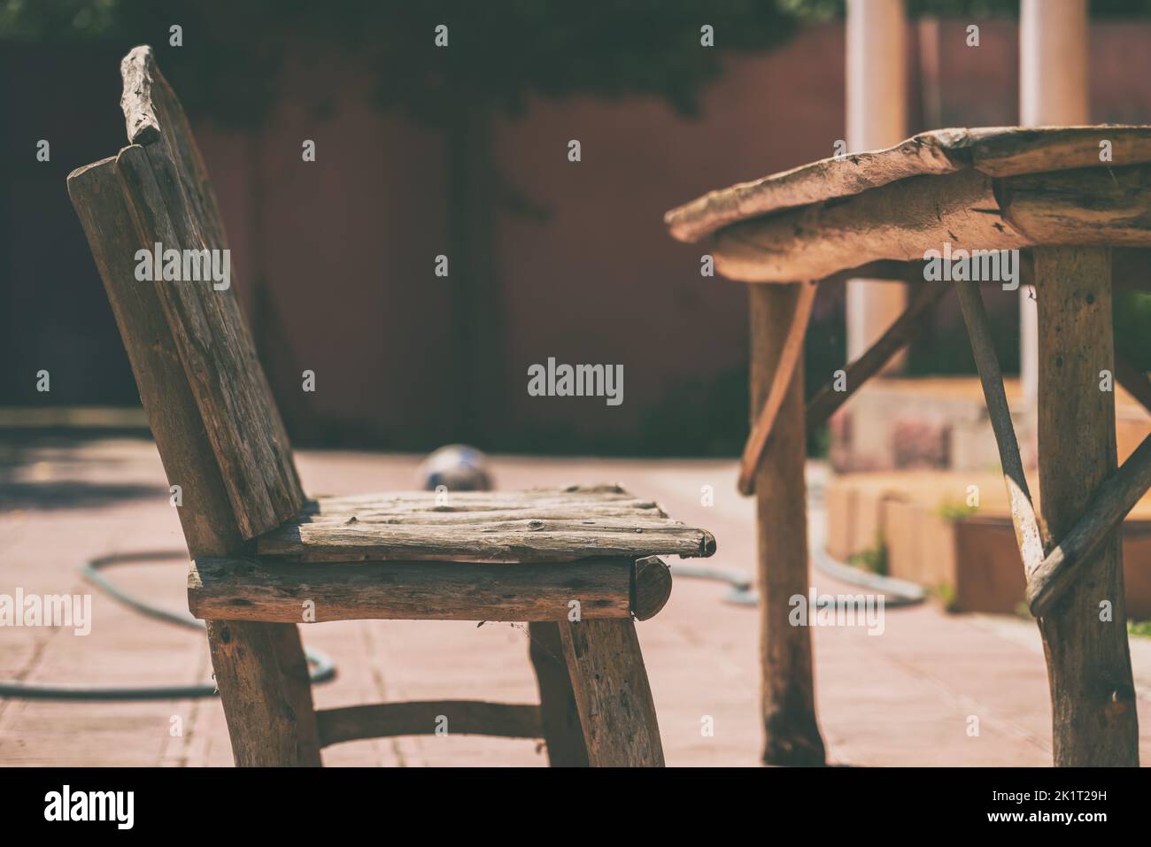 Old handmade wooden table with a bench Stock Photo