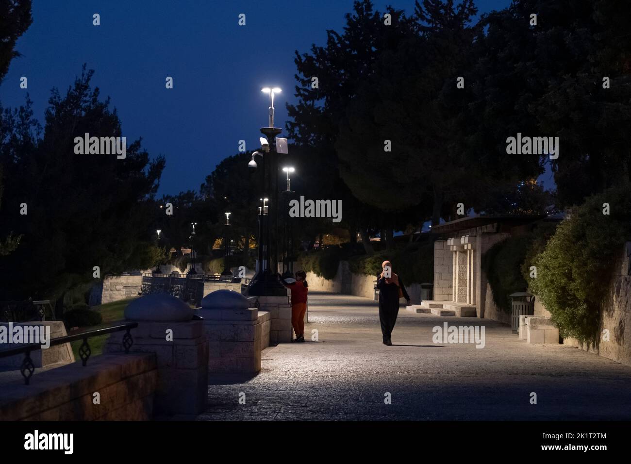 Palestinians walk at night in the Tayelet Haas Promenade in Armon Hanatziv in Jerusalem Israel Stock Photo
